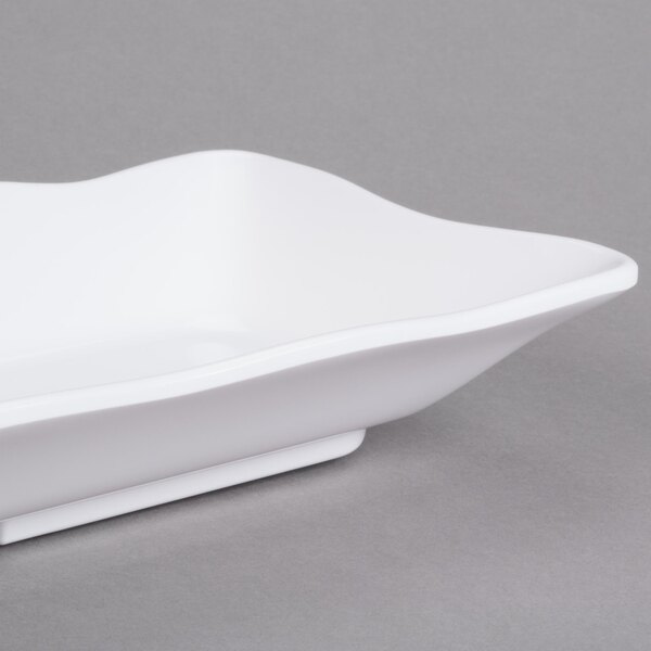 A white rectangular melamine tray with scalloped edges.