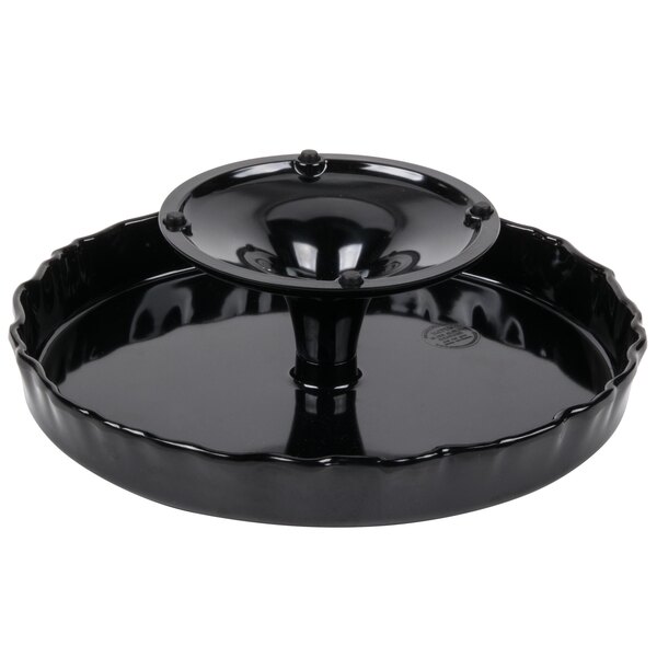 A black round tray with a ruffled edge on a pedestal.