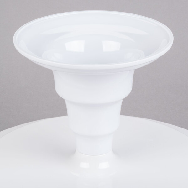 A white Elite Global Solutions round melamine plate stand on a white table.