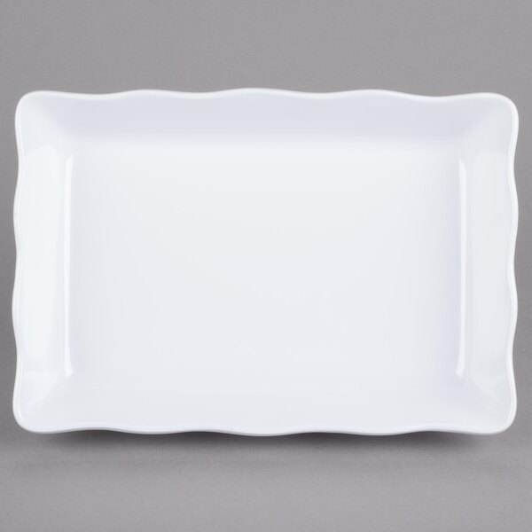 A white rectangular tray with a scalloped edge.
