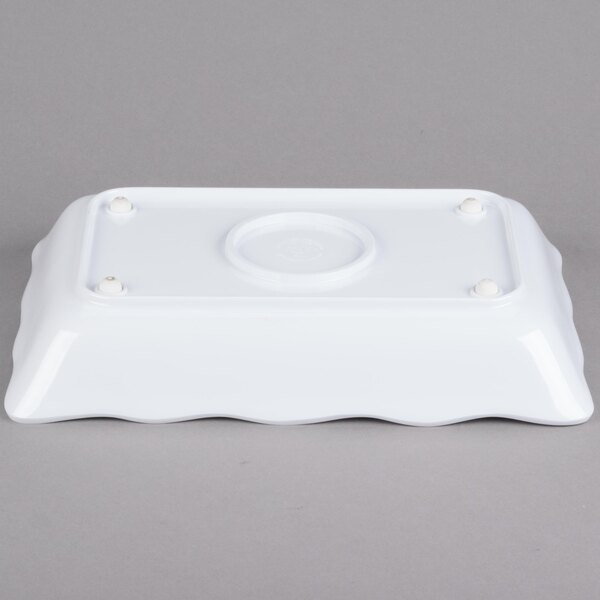 A white rectangular melamine tray with scalloped edges.