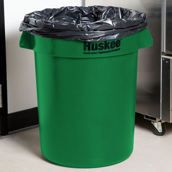 A close-up of a green Continental 32 gallon round trash can with black plastic on top.