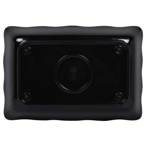 A black rectangular tray with a scalloped black border and a circular center.