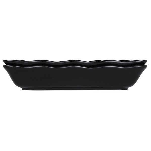 A black rectangular Elite Global Solutions melamine tray with wavy edges.