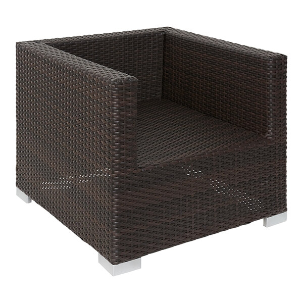 A brown wicker BFM Seating Aruba armchair with metal armrests.