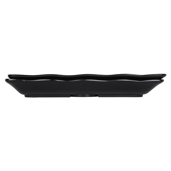 A black rectangular melamine tray with a wavy edge.
