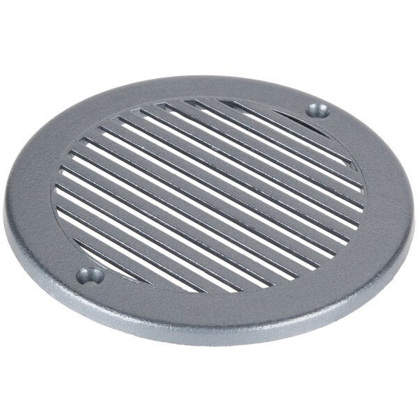 A round metal drain cover with holes.