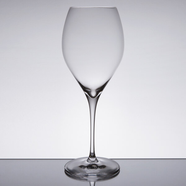 A clear Spiegelau Adina Prestige Bordeaux wine glass on a table.
