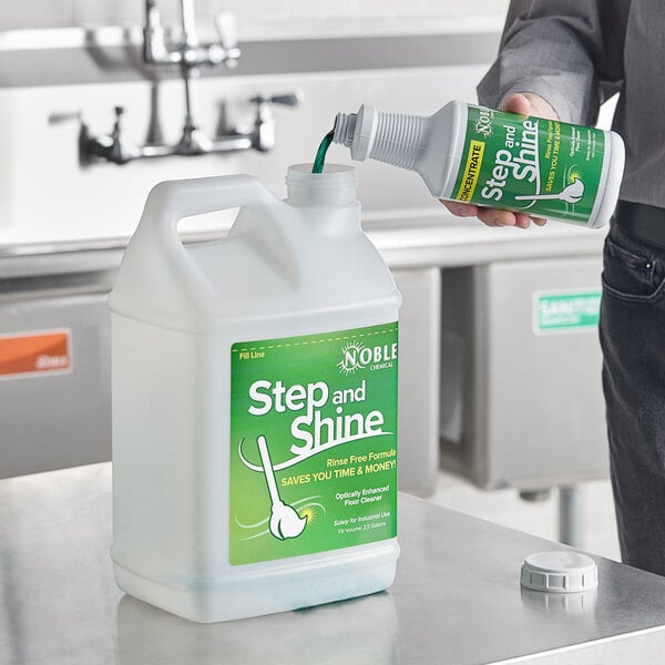 A person pouring Noble Chemical Step and Shine liquid into a white jug.