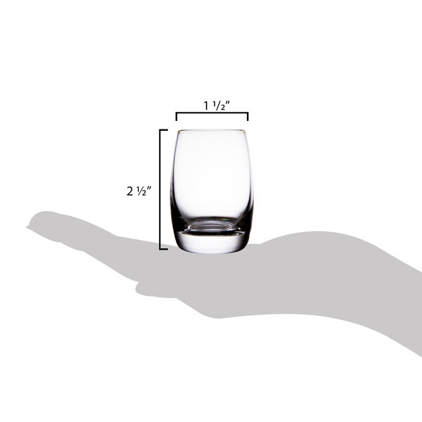 A hand holding a Spiegelau Vino Grande shot glass with measurements.
