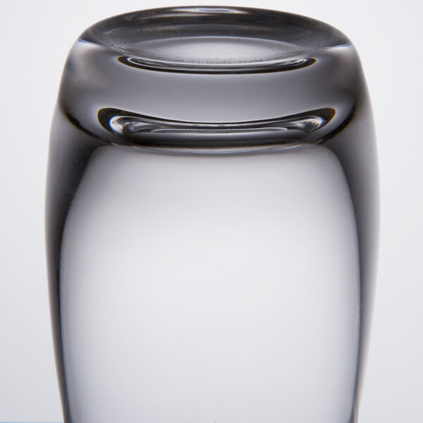 A close up of a Spiegelau Vino Grande shot glass on a table in a cocktail bar.