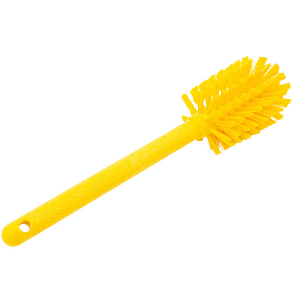 A yellow Carlisle Sparta Spectrum bottle cleaning brush with a handle.