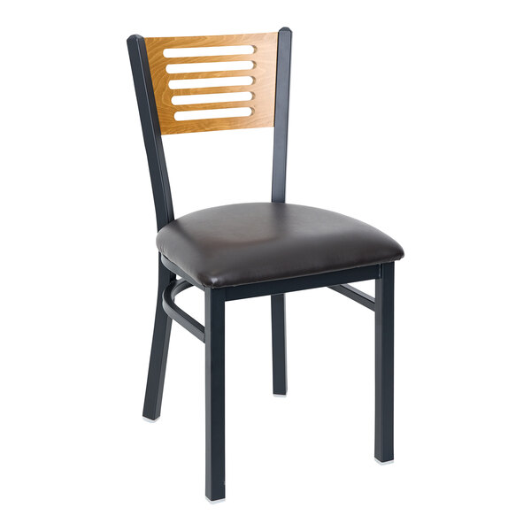 A BFM Seating black metal side chair with a cherry wooden back and black vinyl seat.