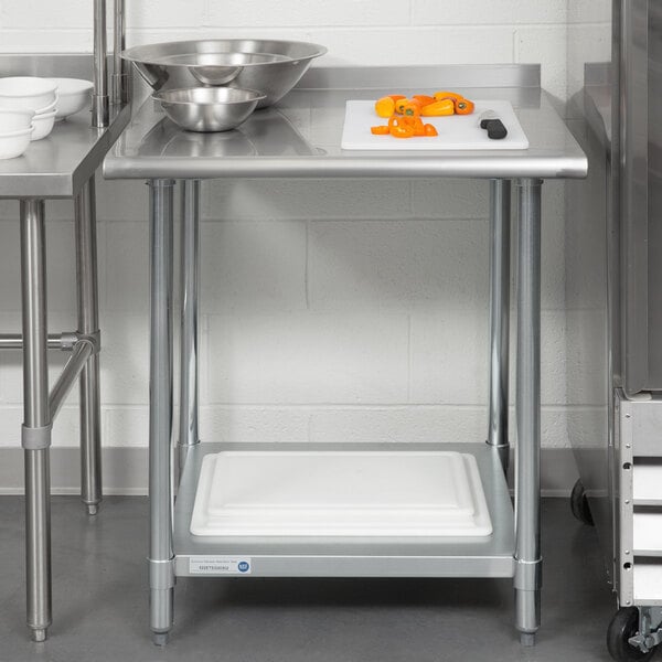A Steelton stainless steel work table with an undershelf and rear upturn on a table with food.