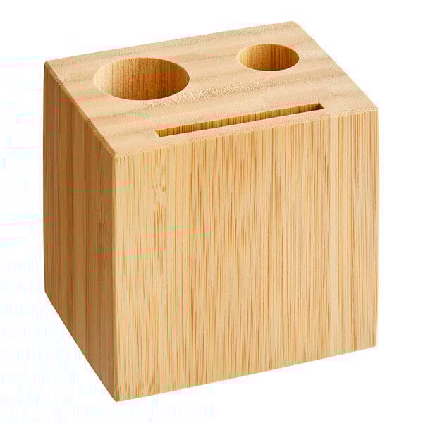 An American Metalcraft bamboo block check presenter with two holes on a table.
