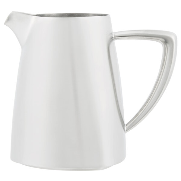 A close-up of a stainless steel Vollrath creamer with a white handle.
