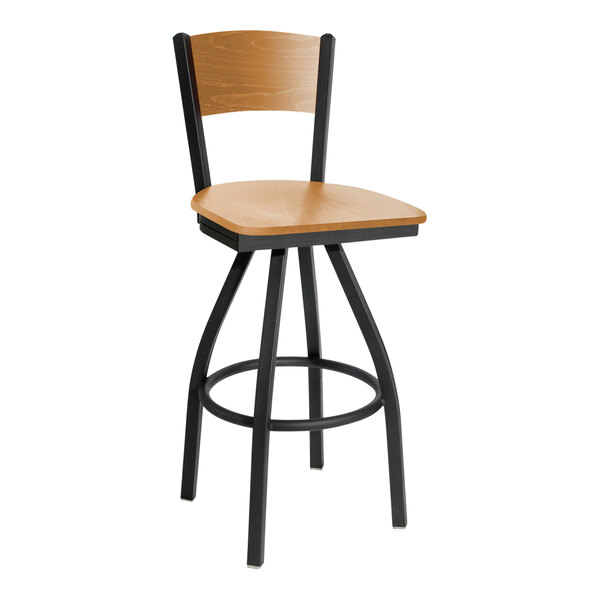 A BFM Seating black metal swivel bar stool with a cherry wood back and seat.