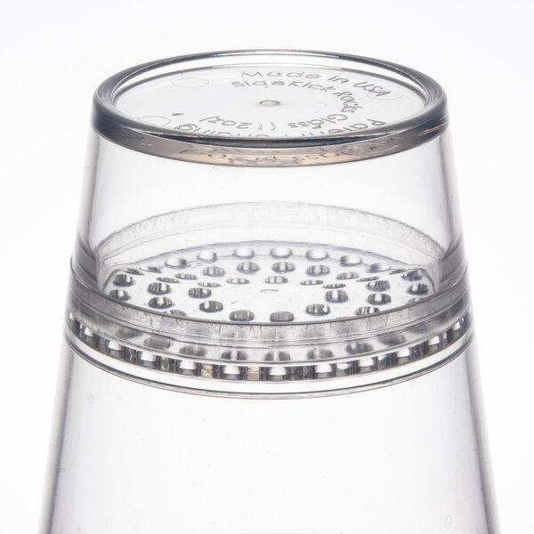 A clear plastic cup with a silver rim.
