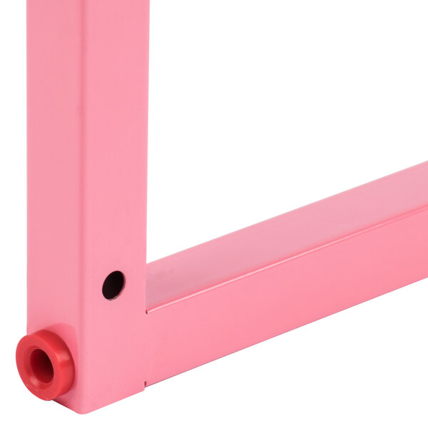 A pink metal Carnival King wheel frame with a hole in the middle.