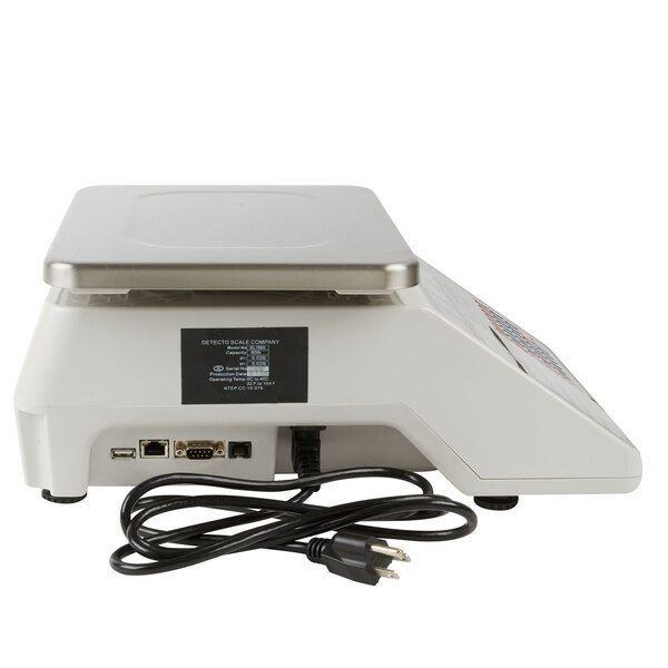 A white Cardinal Detecto digital price computing scale with a black power cord.