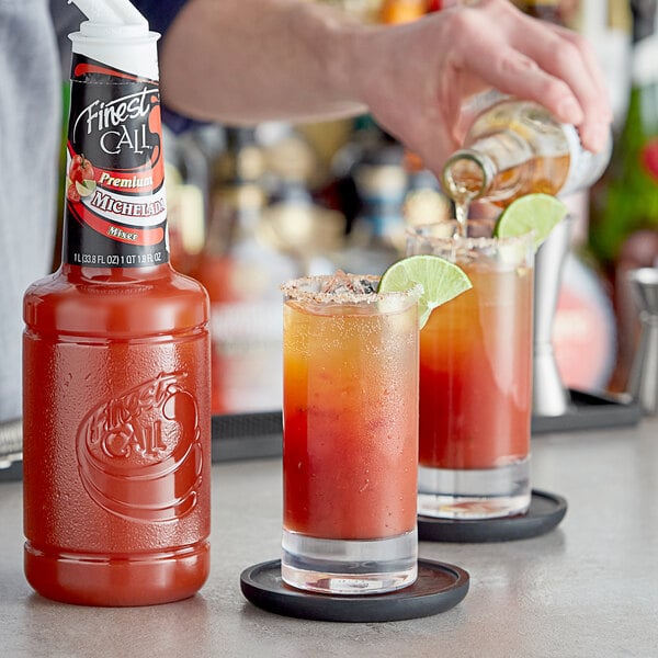 A person pours Finest Call Michelada Mix into a glass.