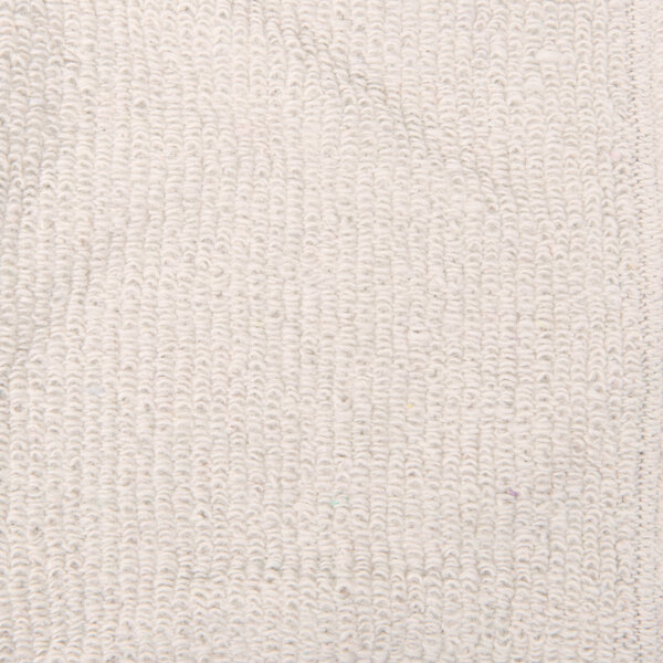 A close-up of a white terry cloth sleeve with a textured pattern.
