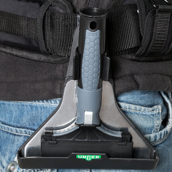 A black holster with a safety cap attached to a black strap.