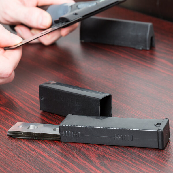 A person holding a Unger ErgoTec Ninja stainless steel blade.