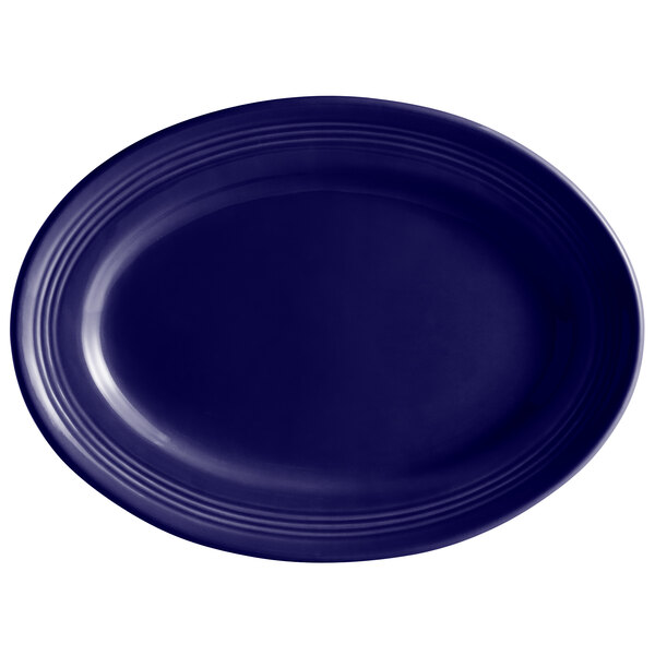 A cobalt blue oval Tuxton china platter with a white background.