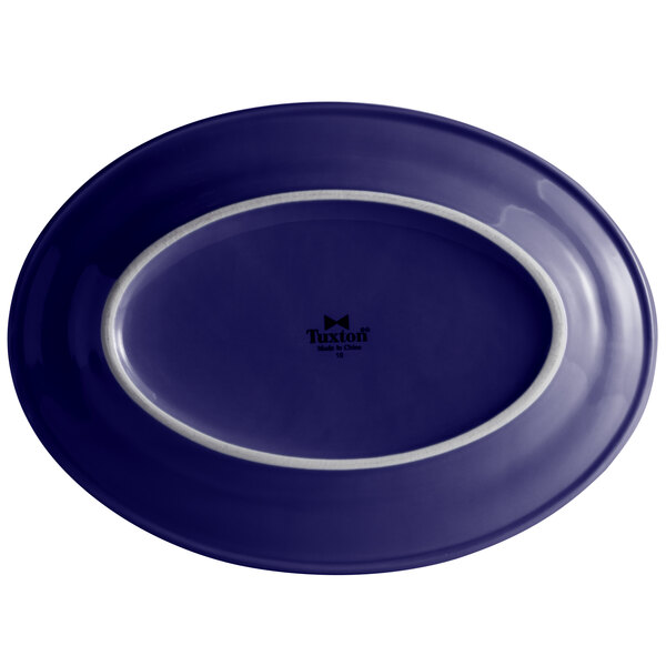 A blue oval china platter with a white rim.