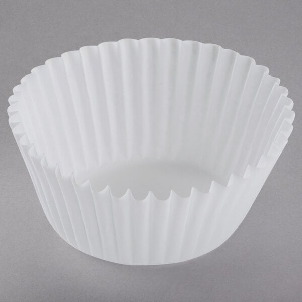 A white fluted baking cup on a white background.