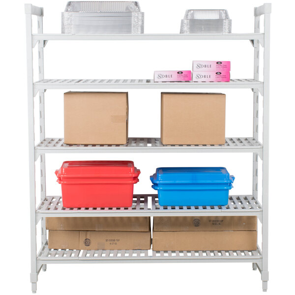 A white Cambro Camshelving® Premium shelving unit with boxes and plastic containers on the shelves.