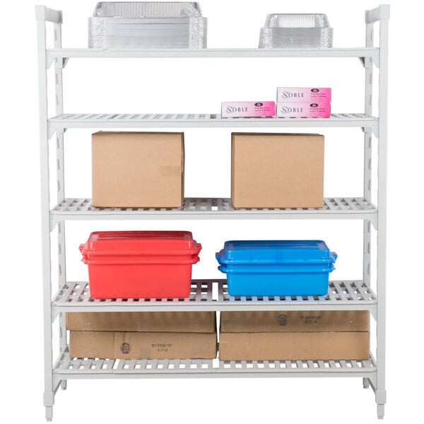 A white Cambro Camshelving Premium shelving unit with boxes and plastic containers on the shelves.