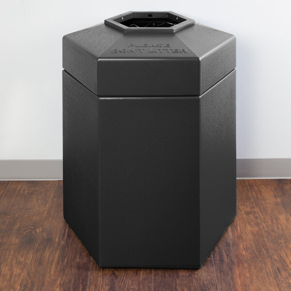 A black hexagonal PolyTec waste container with an open top.