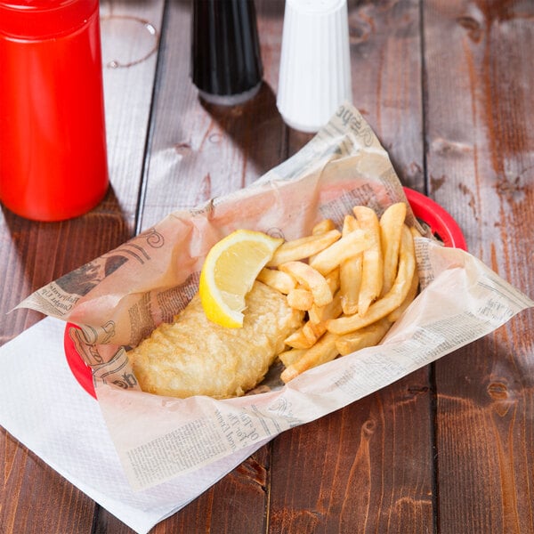 A fish and chips in a basket lined with American Metalcraft newspaper deli wrap.