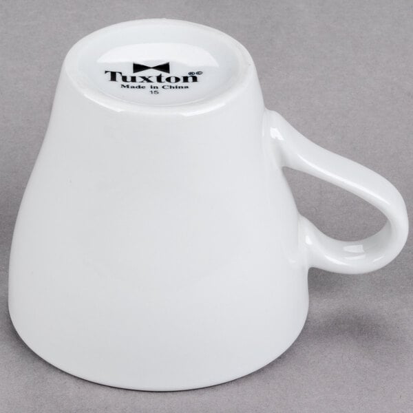 A white porcelain Tuxton cappuccino mug with a handle.