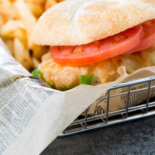 A sandwich with American Metalcraft Natural Newspaper Wrap in a basket.