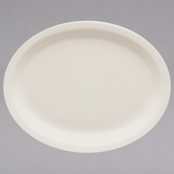A white Homer Laughlin narrow rim oval china platter on a white surface.