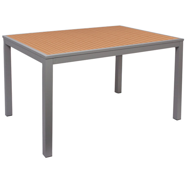 A BFM Seating rectangular table with a synthetic teak top and metal legs.