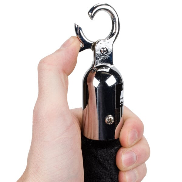 A hand holding a black Aarco stanchion rope with chrome ends.