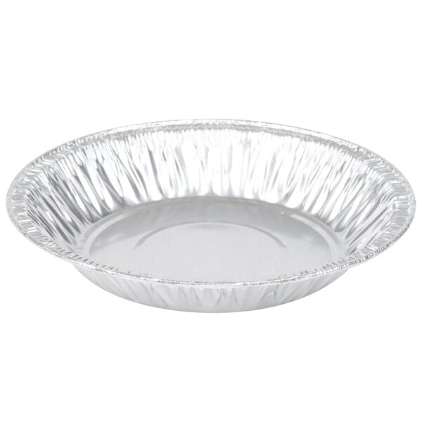 A close-up of a round silver D&W Fine Pack shallow foil pie pan.
