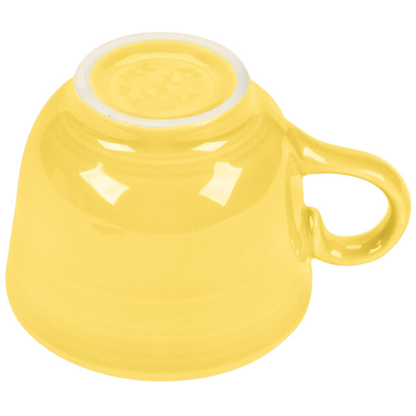 A Fiesta sunflower yellow china cup with a handle.