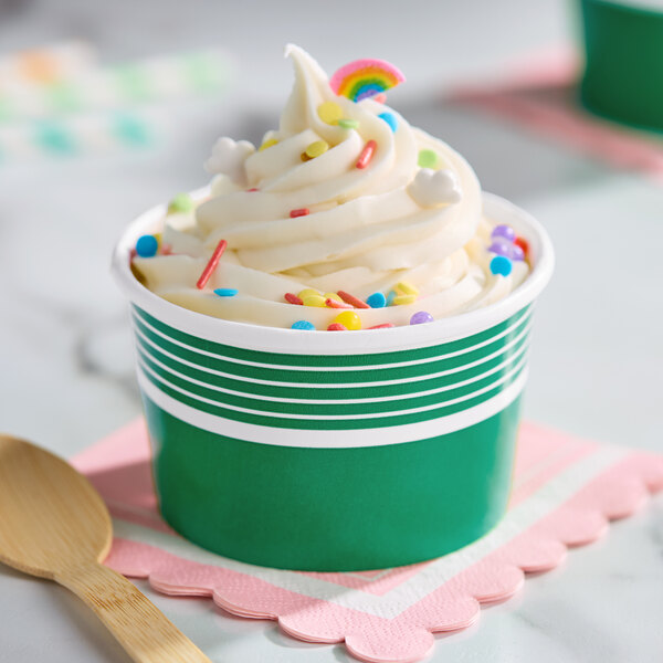 An 8 oz. green paper cup filled with frozen yogurt and colorful sprinkles.