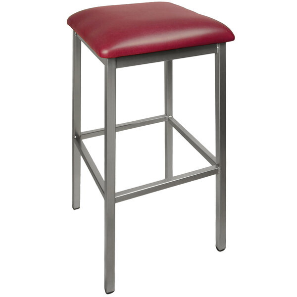 A BFM Seating Trent clear coated steel restaurant bar stool with a burgundy vinyl seat.