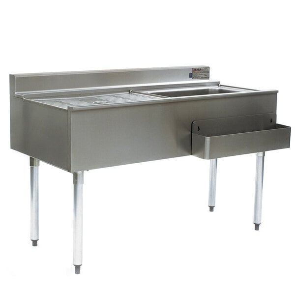 An Eagle Group stainless steel cocktail workstation with a right side ice bin and cold plate on a stand with a stainless steel sink.