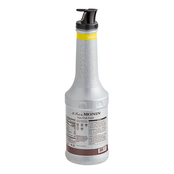 A Monin 1 liter bottle of Yuzu fruit puree with a yellow cap.