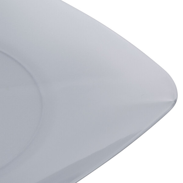 A close up of a Fineline silver square salad plate with a curved edge.