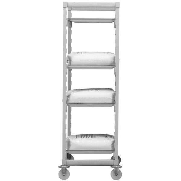 A gray Cambro Camshelving® Premium mobile shelving unit with white shelves holding white plastic bags.