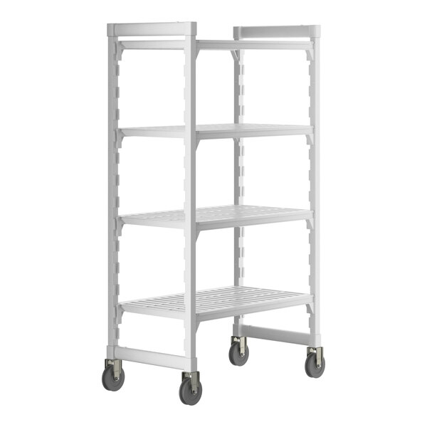 A white Cambro Camshelving Premium mobile shelving unit with vented shelves and wheels.