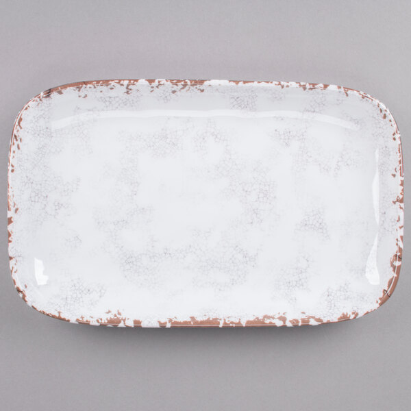 A white rectangular tray with brown speckled edges.